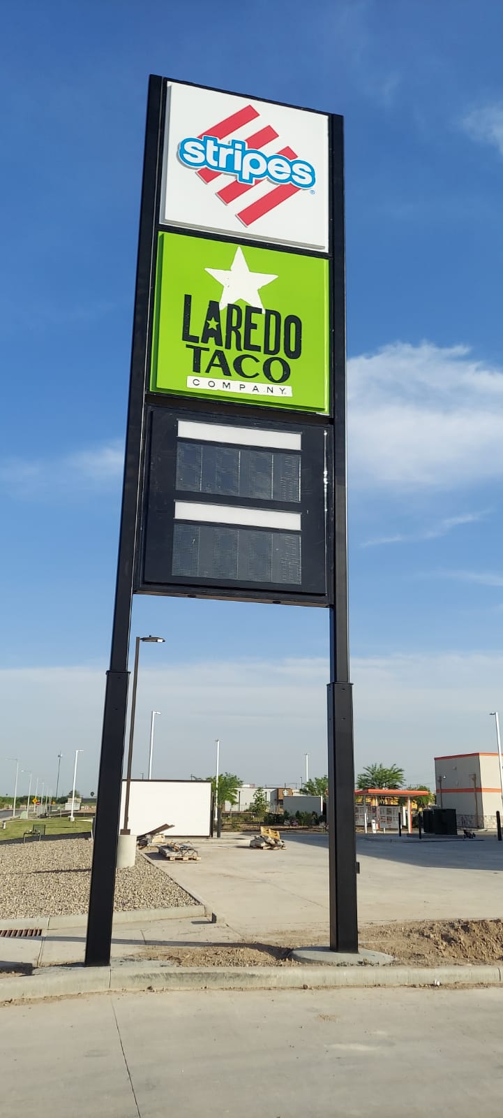 Prominent pylon display for Stripes and Laredo Taco Company, highlighting brand presence and service offerings.